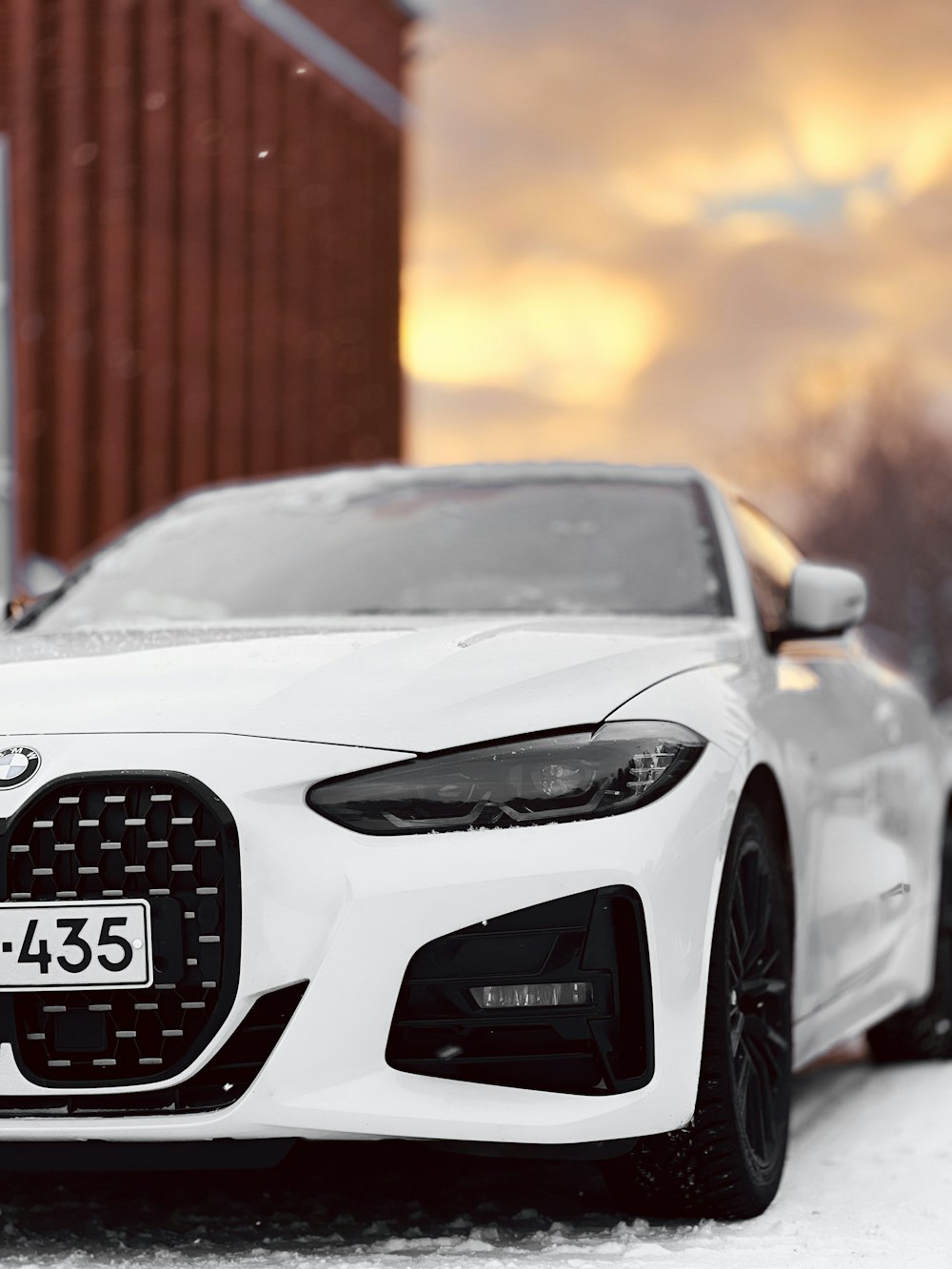 a white car parked in front of a building