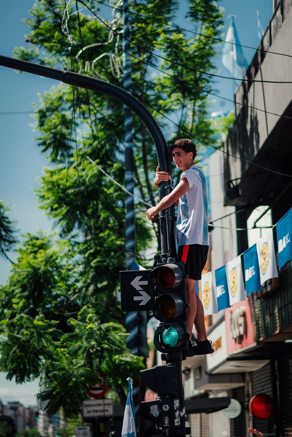 a man standing on top of a traffic light