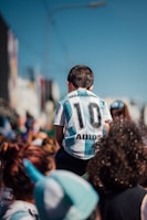 a man in a jersey is standing among a crowd of people