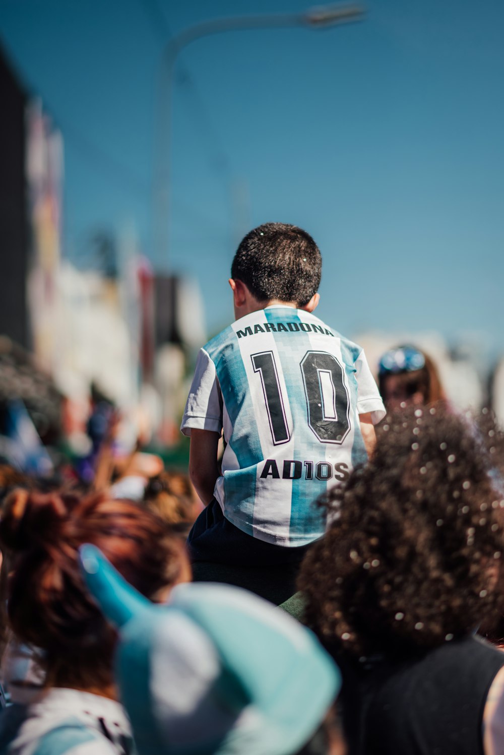 a man in a jersey is standing among a crowd of people