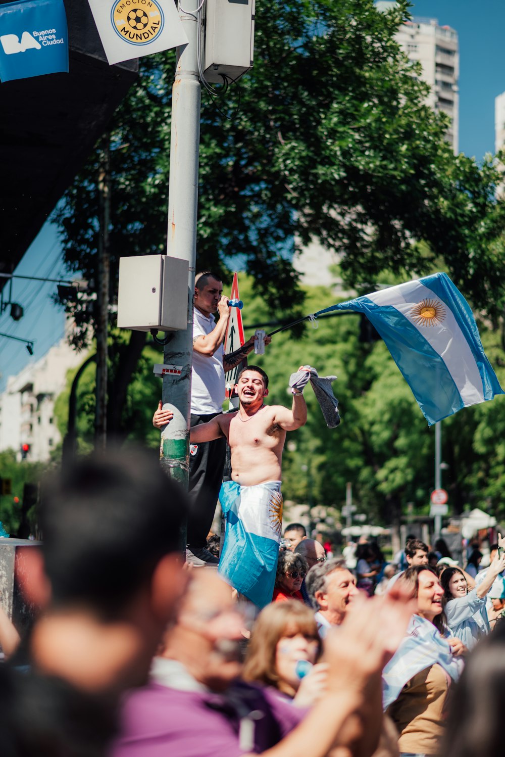 a man holding a flag in the middle of a crowd