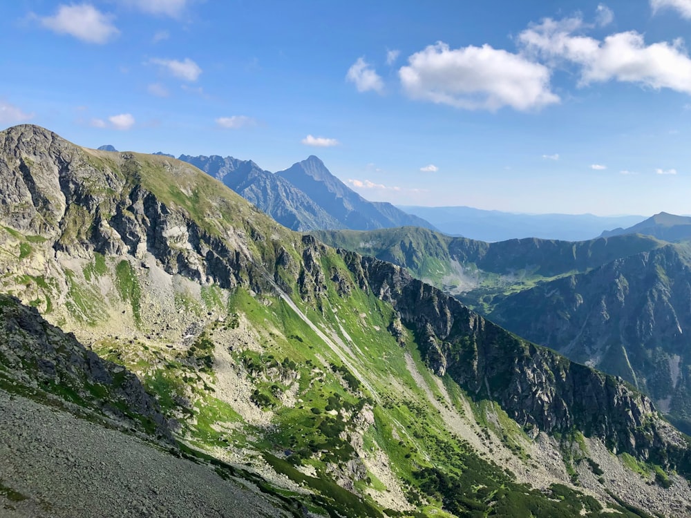 a view of a mountain range from the top of a hill