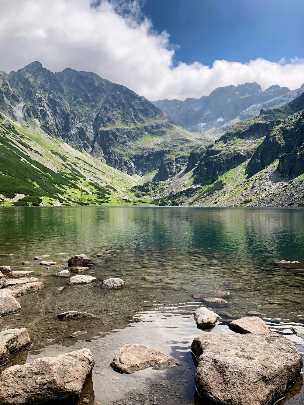 ein Gewässer, umgeben von Bergen und Felsen