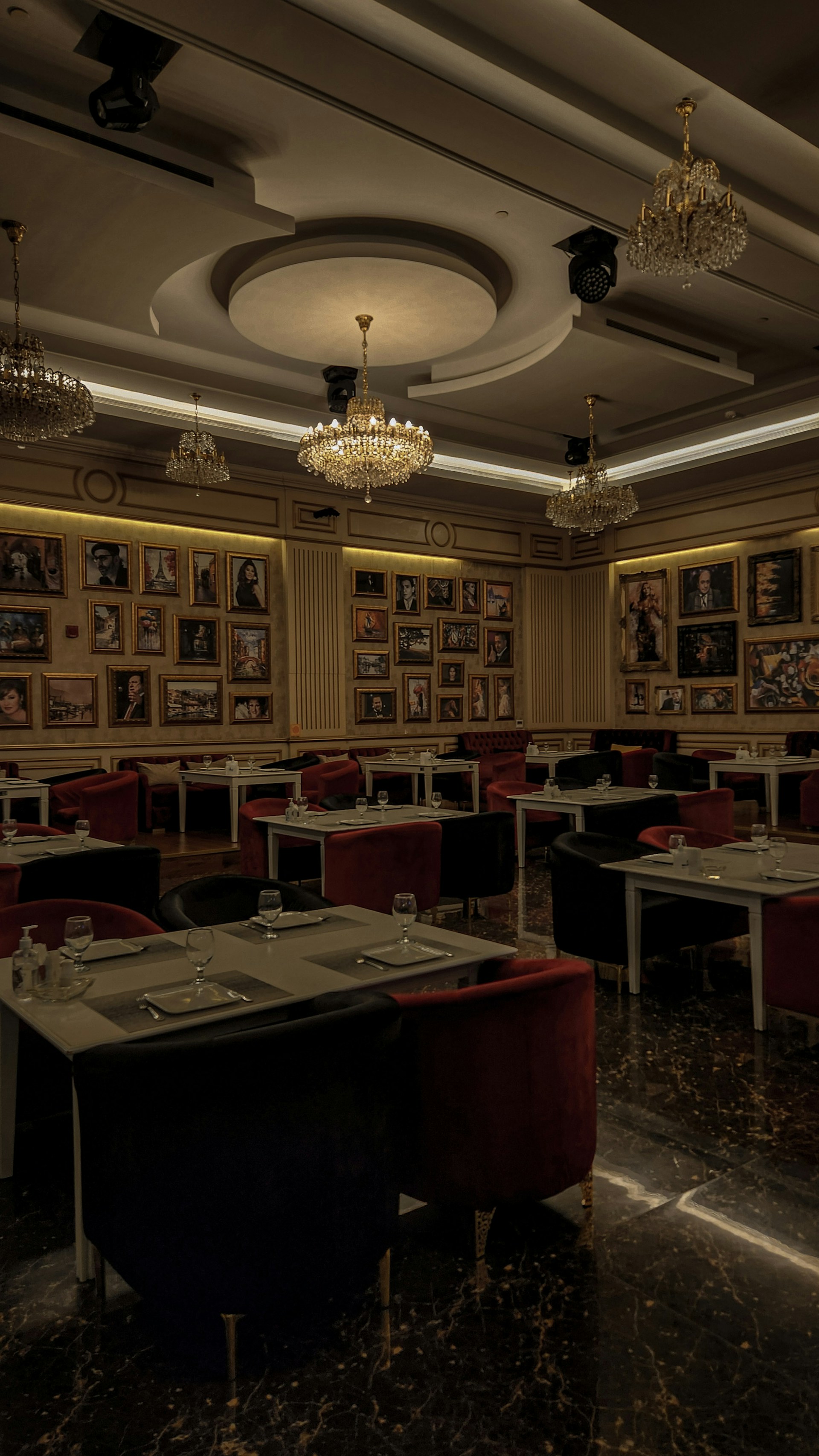 a dimly lit dining room with tables and chairs