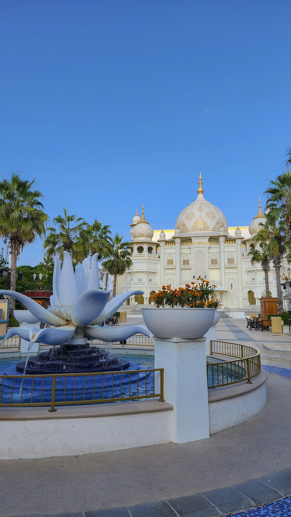 a large white building with a fountain in front of it