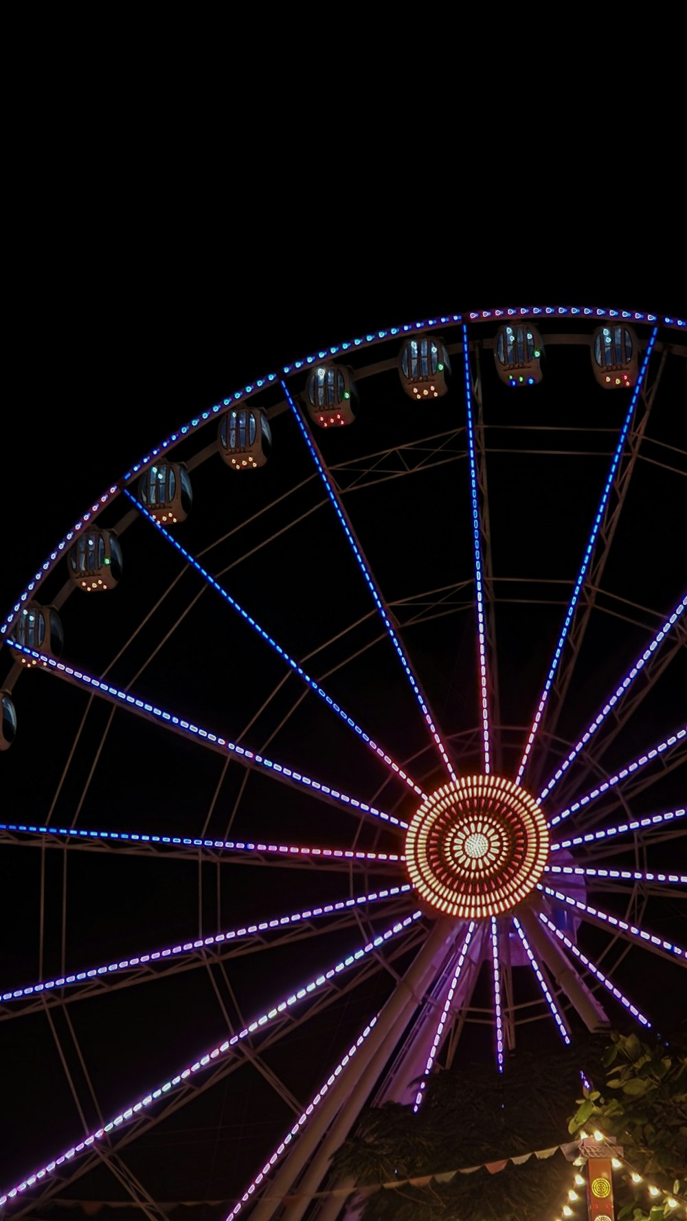 a ferris wheel lit up at night with lights