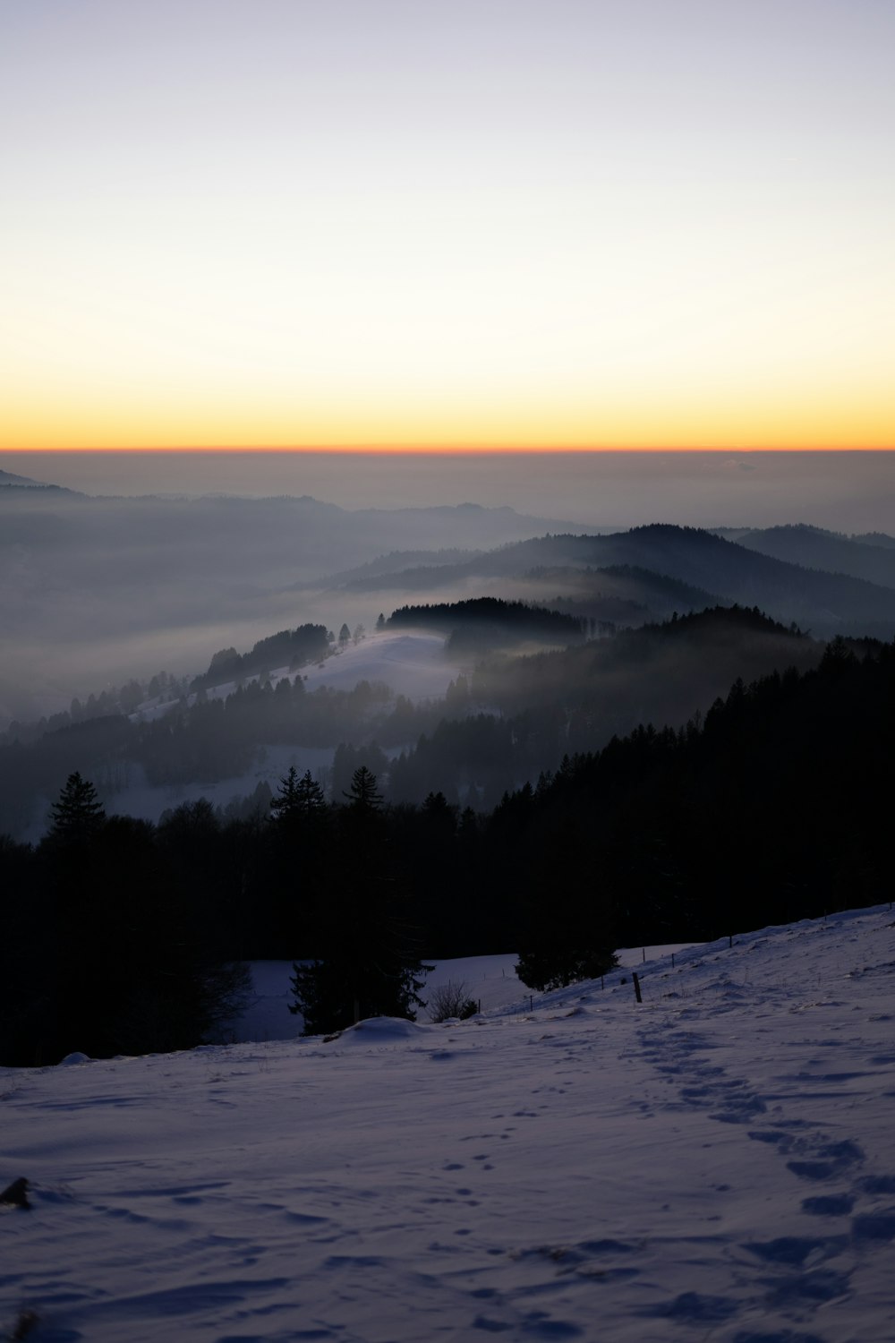 a view of a mountain covered in fog