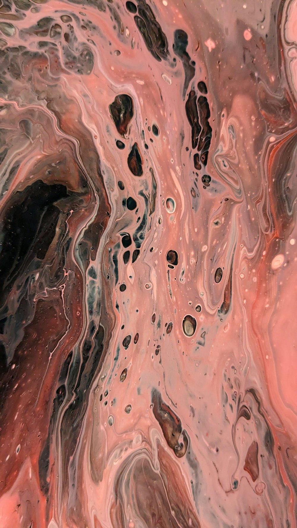 a close up of a pink and black liquid