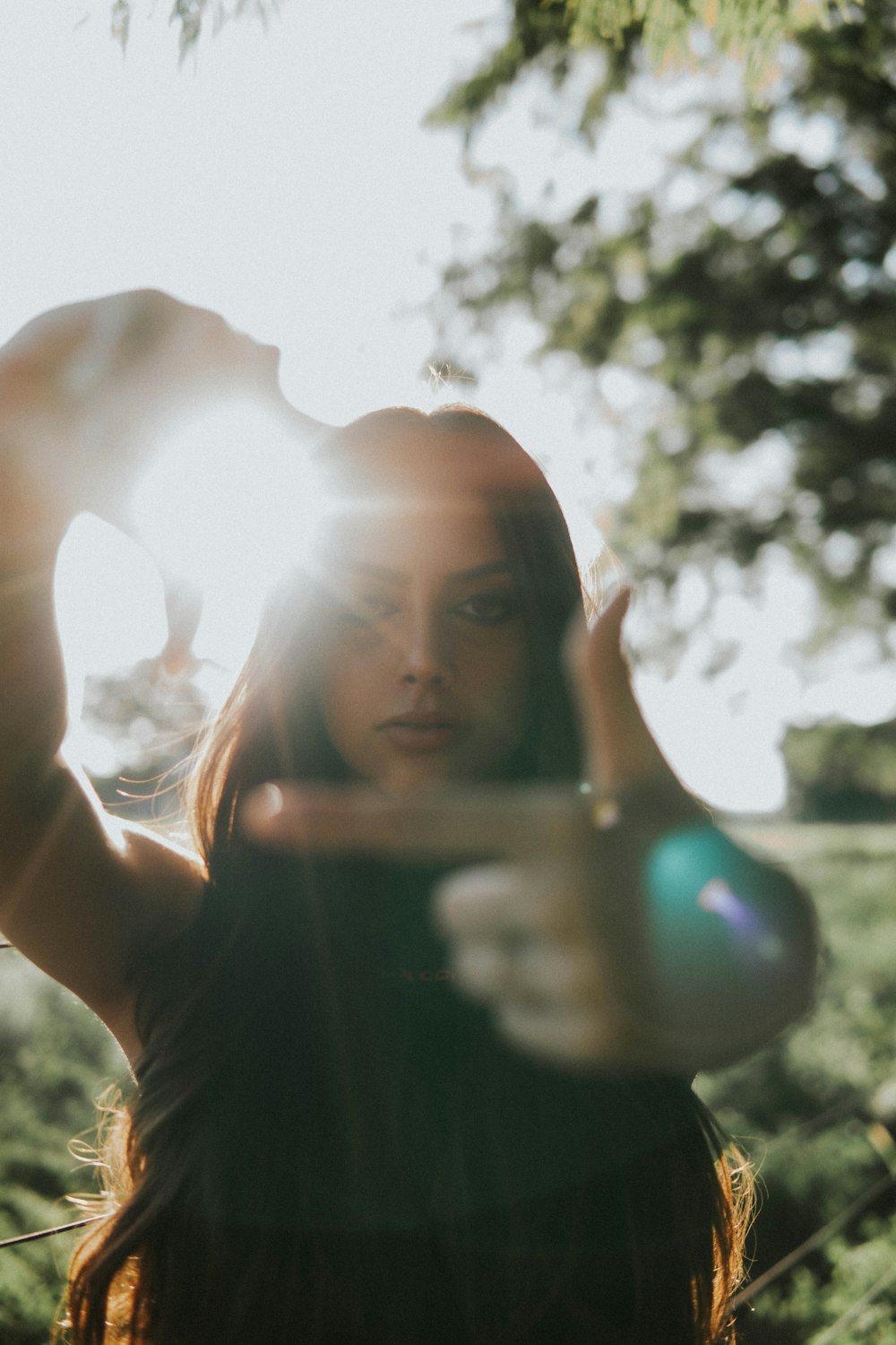 a woman standing in a field holding a frisbee