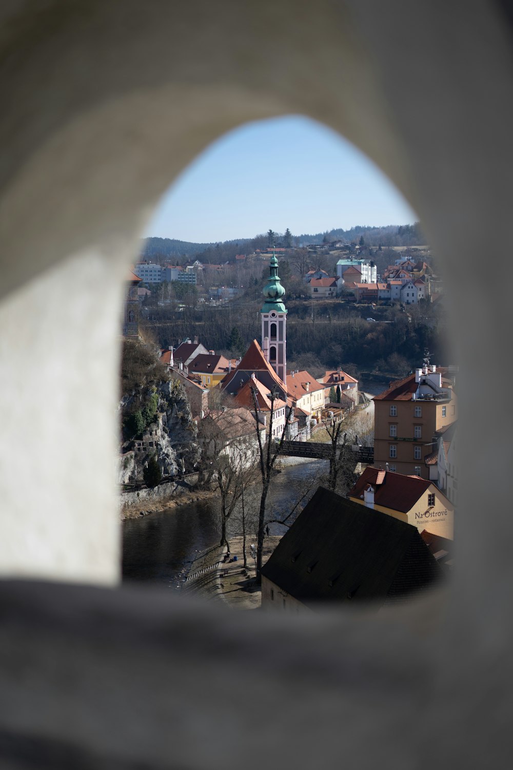 a view of a city through a hole in a wall