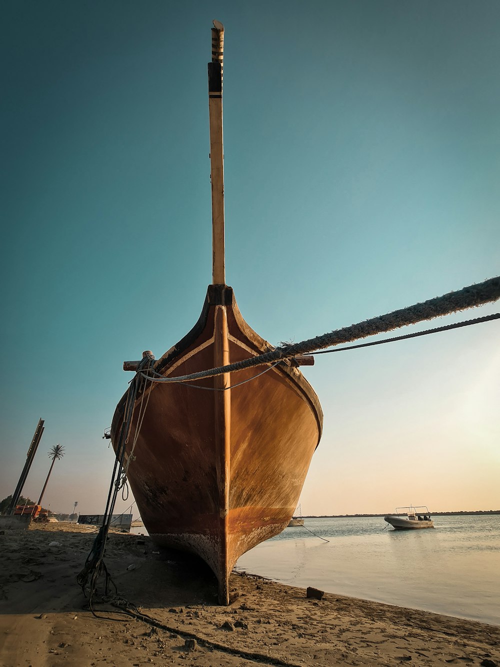 a boat sitting on top of a sandy beach