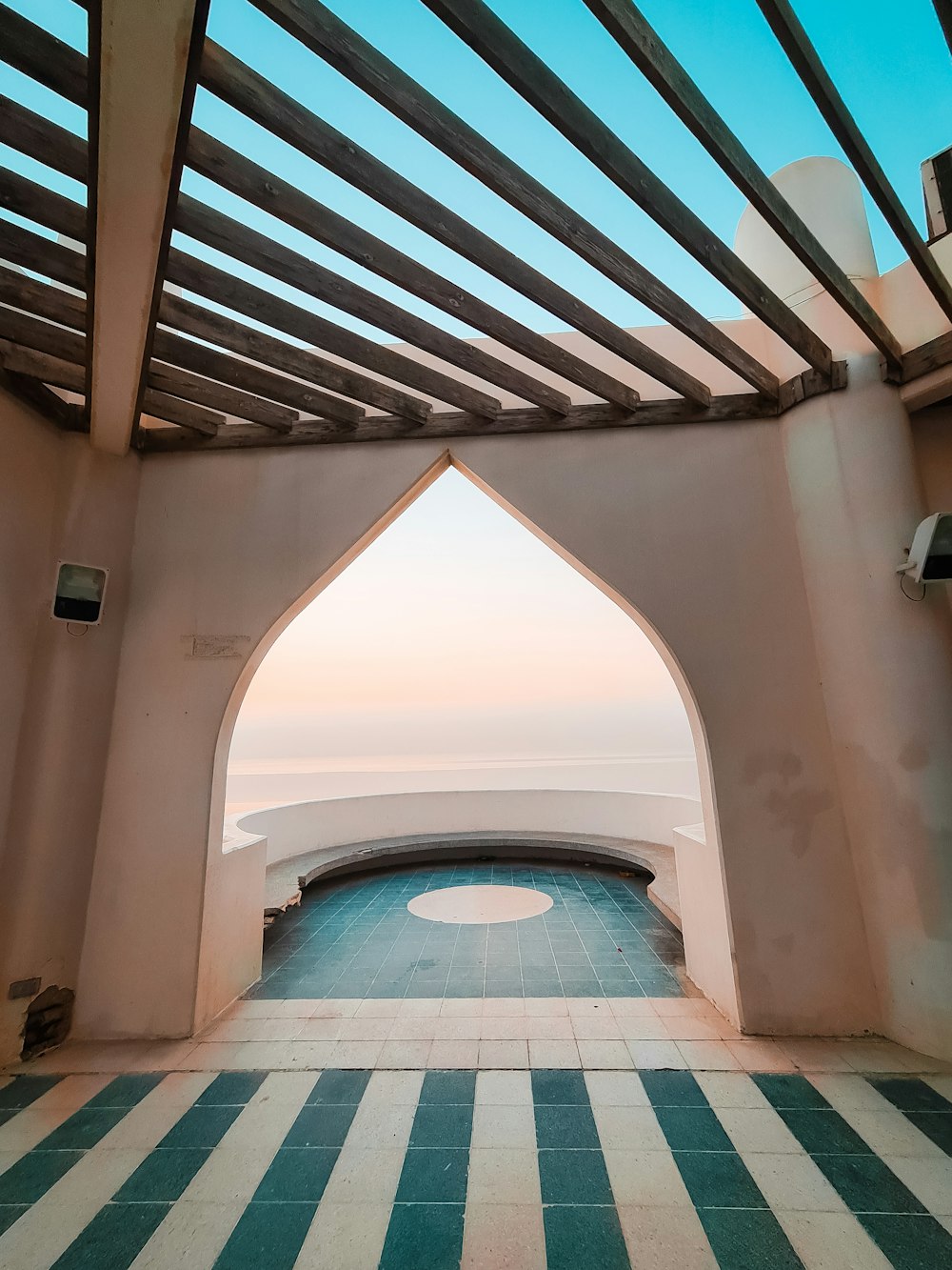a view of the ocean through an arch in a building