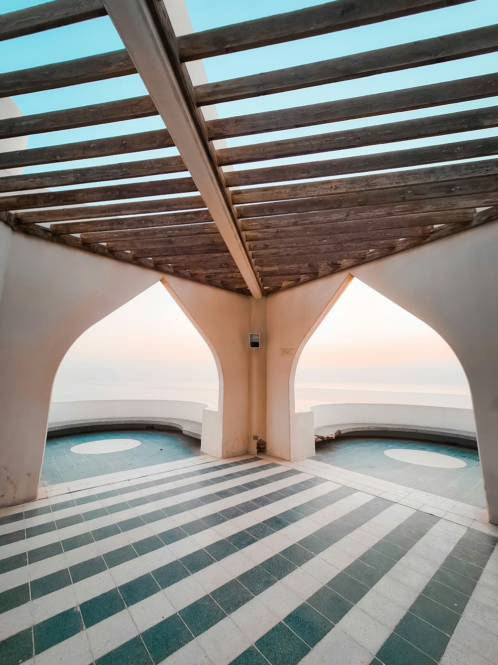 a room with a tiled floor and a view of the ocean