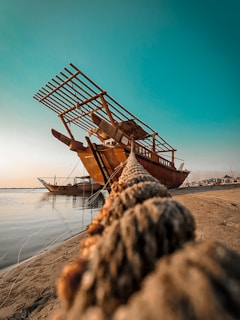 a boat sitting on top of a sandy beach
