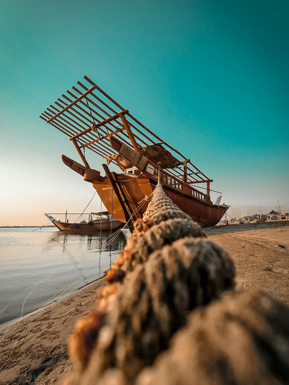 a boat sitting on top of a sandy beach