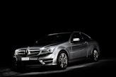 A luxury car ready for an exclusive event, highlighted by sleek lines and a dark, moody background.