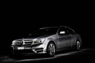 A sleek commercial shoot with golden lighting highlighting a luxury product against a dark backdrop.