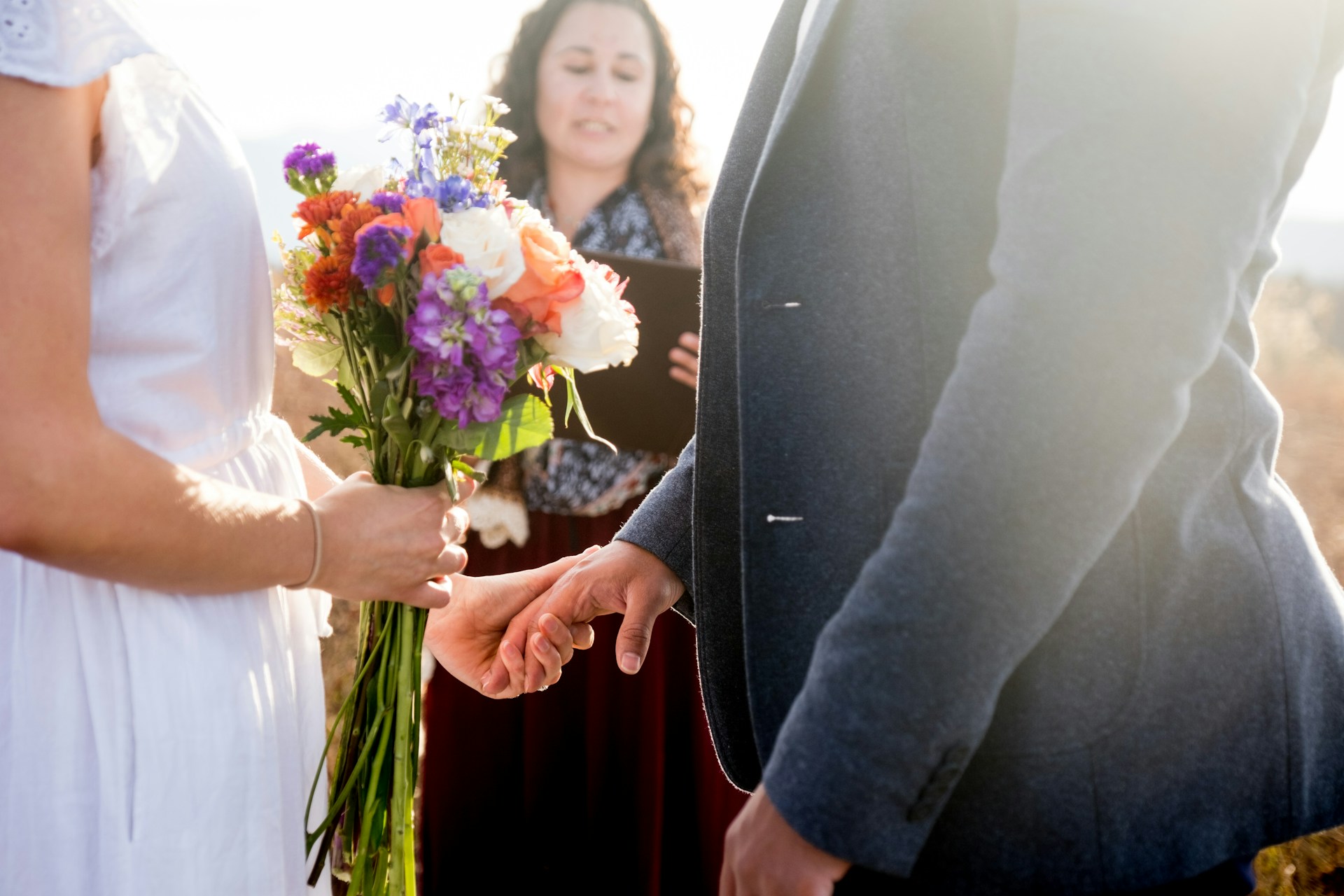 a bride and groom holding hands during a wedding ceremony