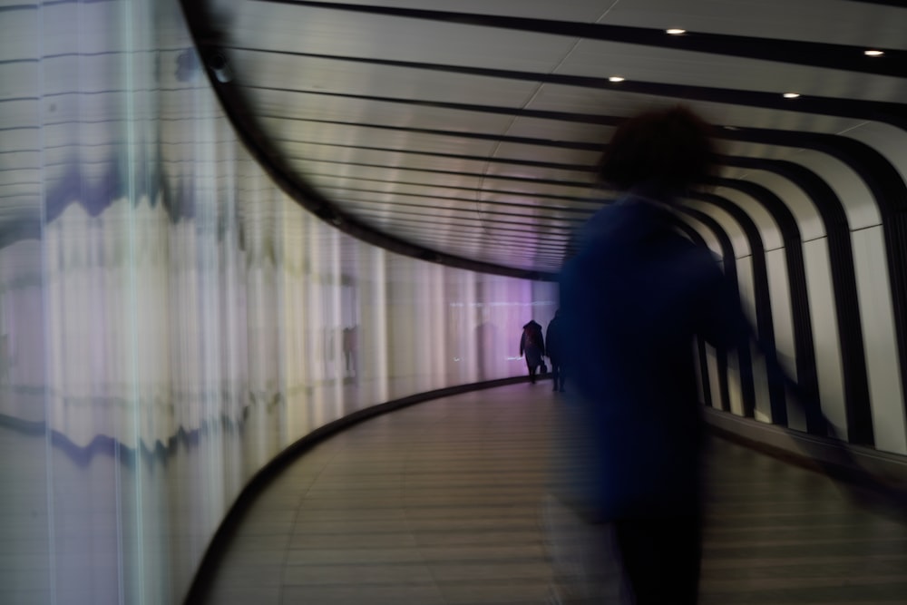 a blurry photo of a person walking down a walkway