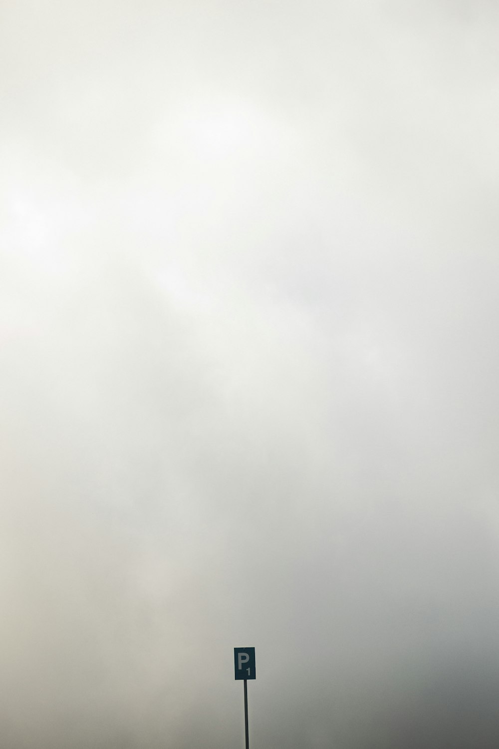 a street sign in front of a cloudy sky