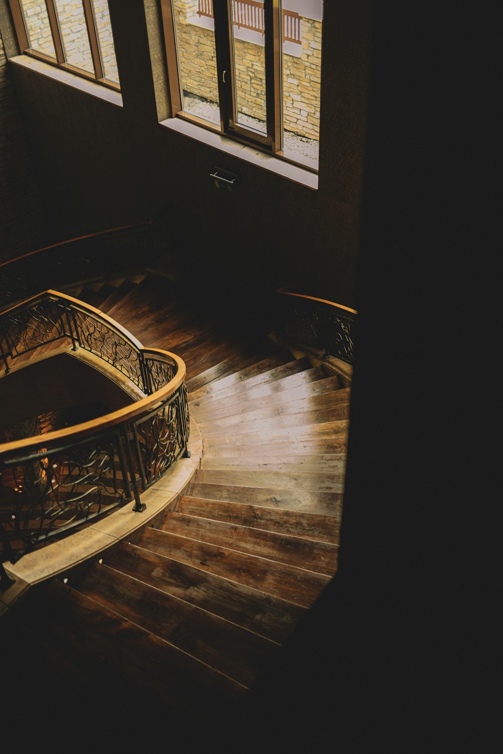 a spiral staircase in a building with wooden floors