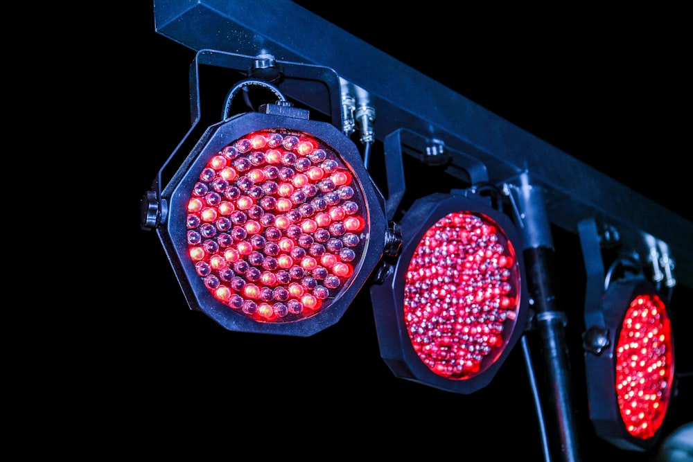 a close up of two traffic lights on a pole