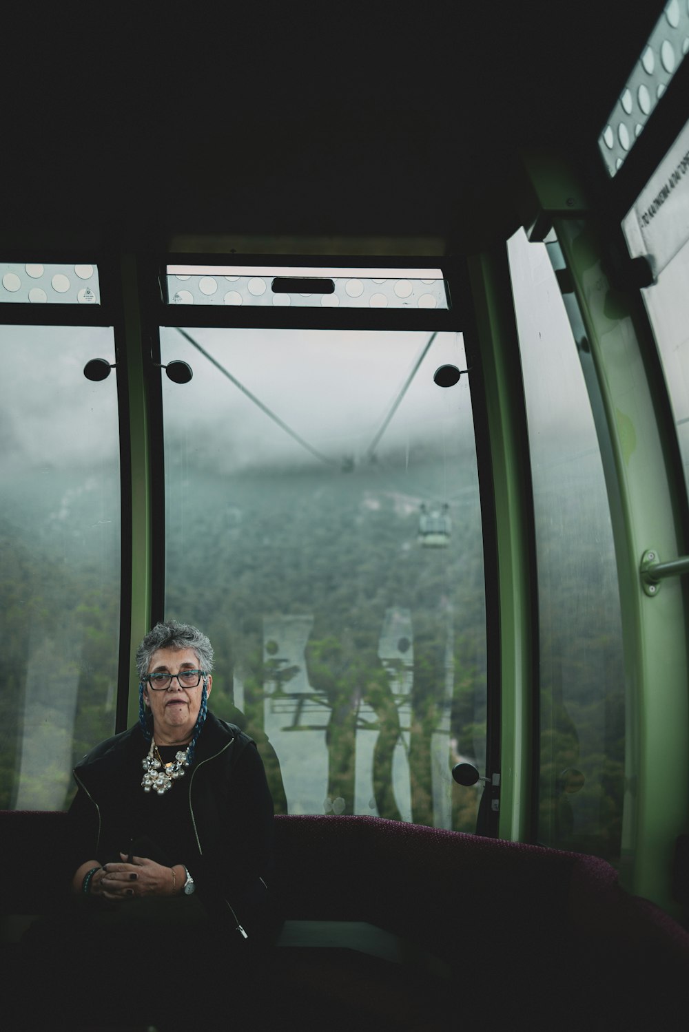 a man sitting in a chair looking out a window