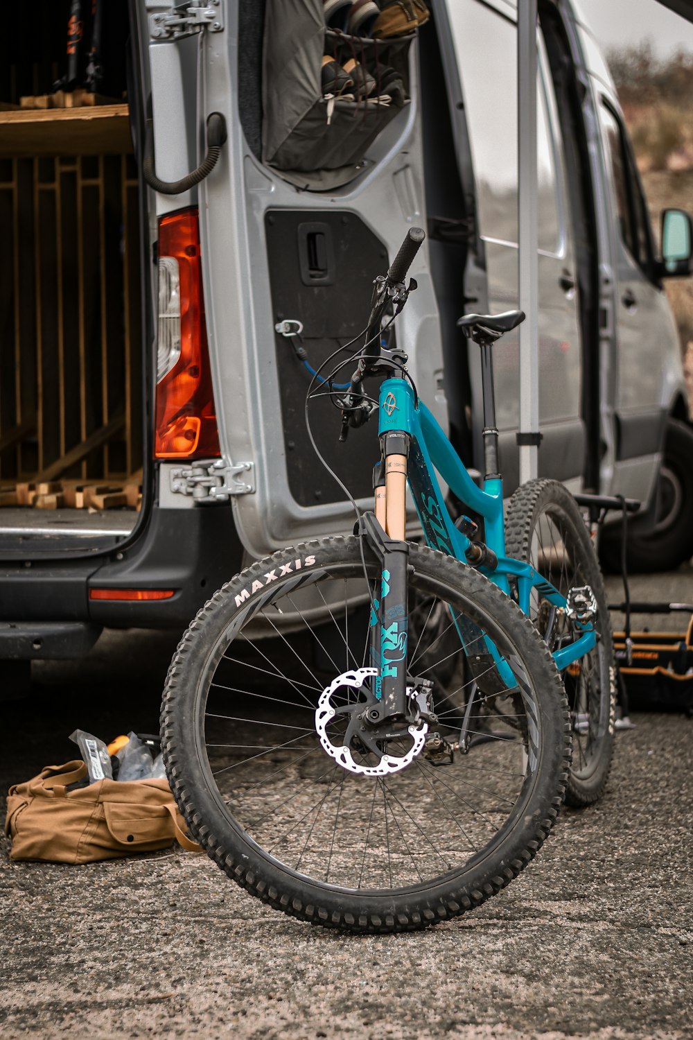 a blue bicycle parked next to a van