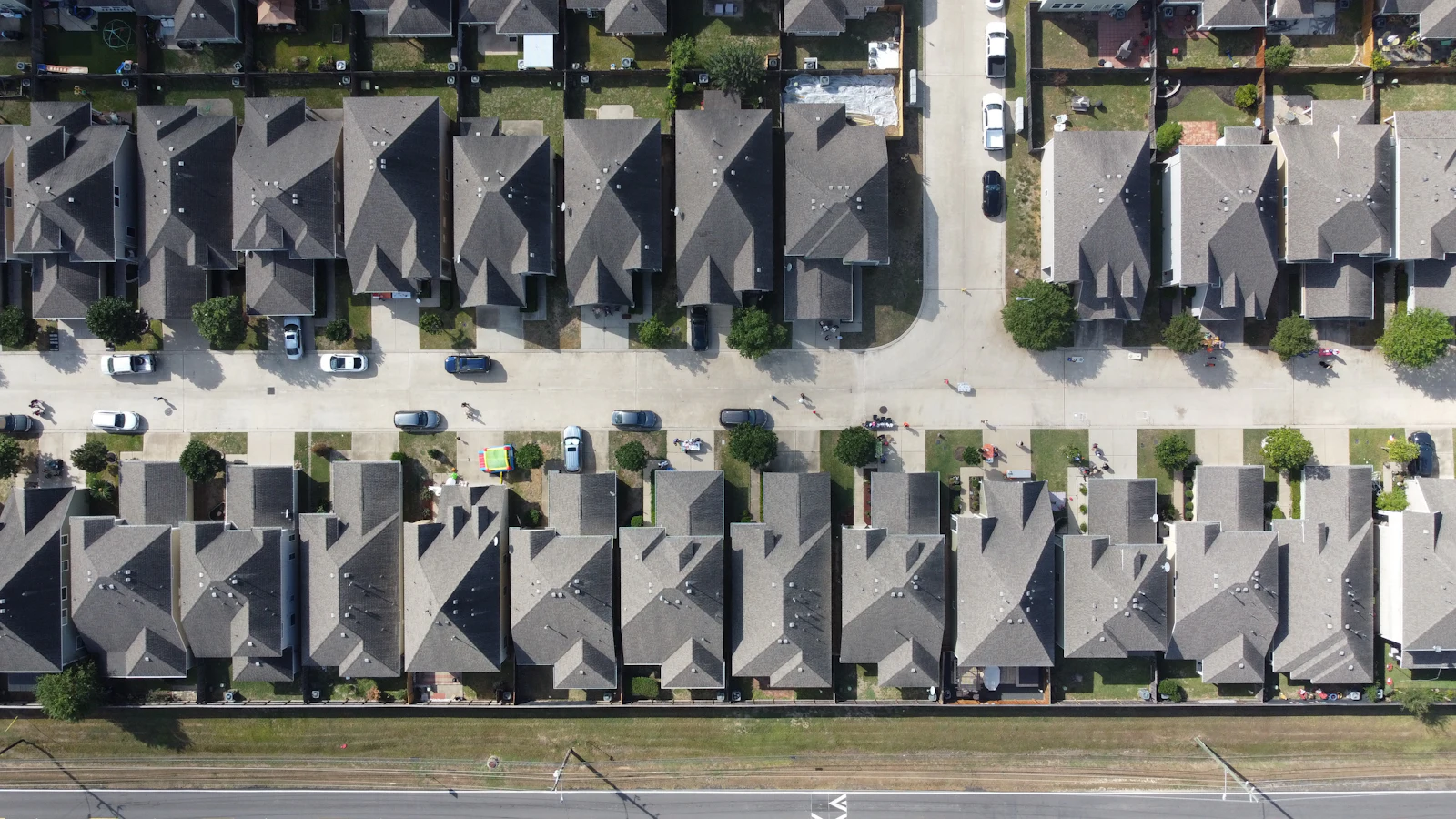An aerial view of rows of two-story houses.