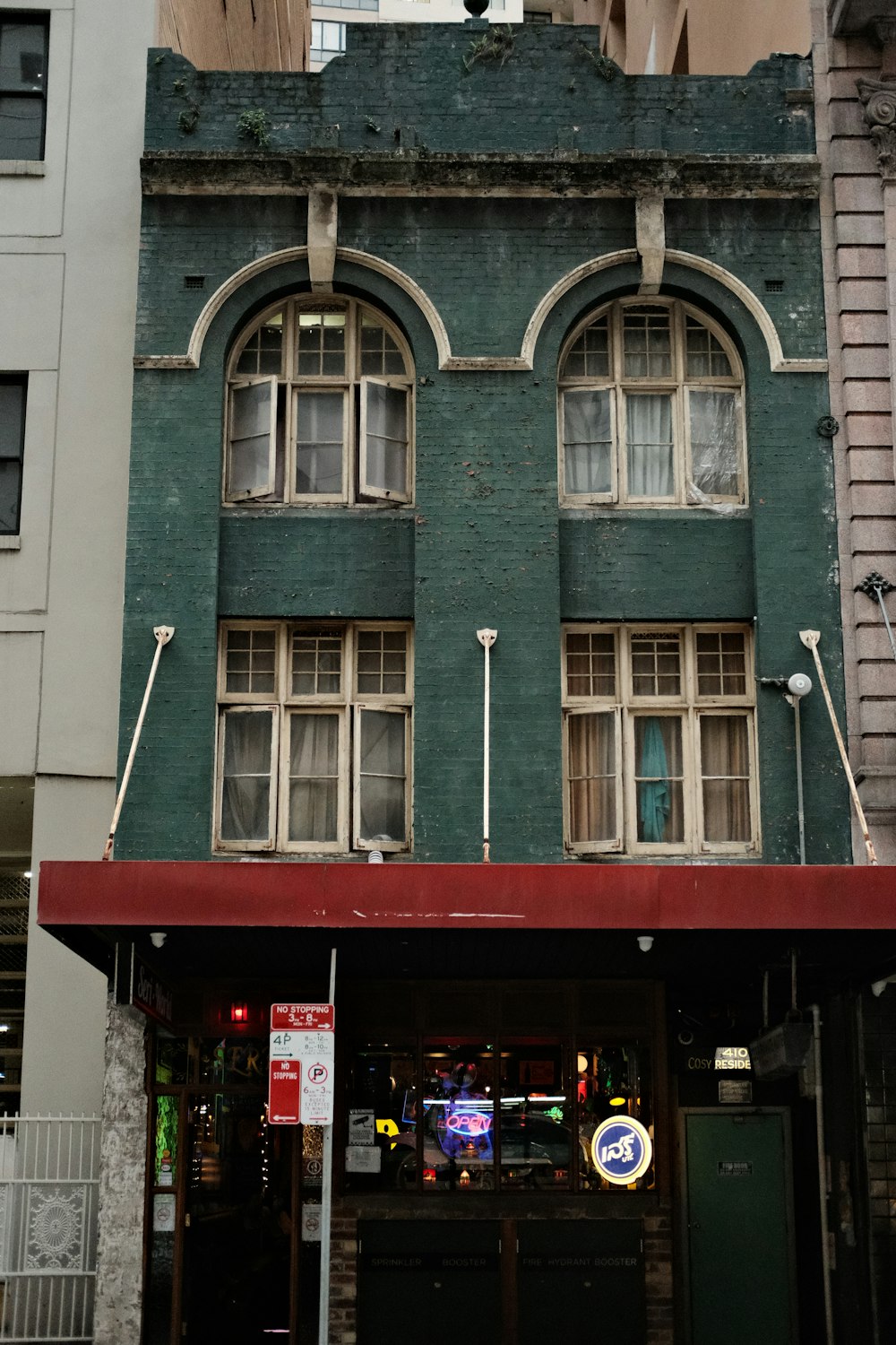 a tall building with a red awning on top of it