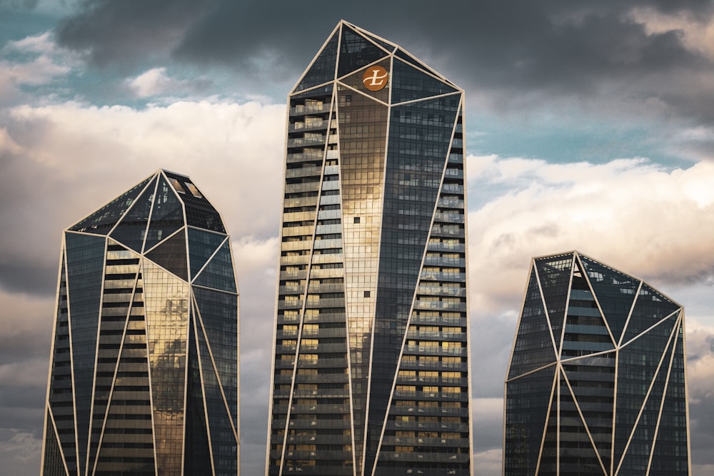 a group of skyscrapers with a cloudy sky in the background