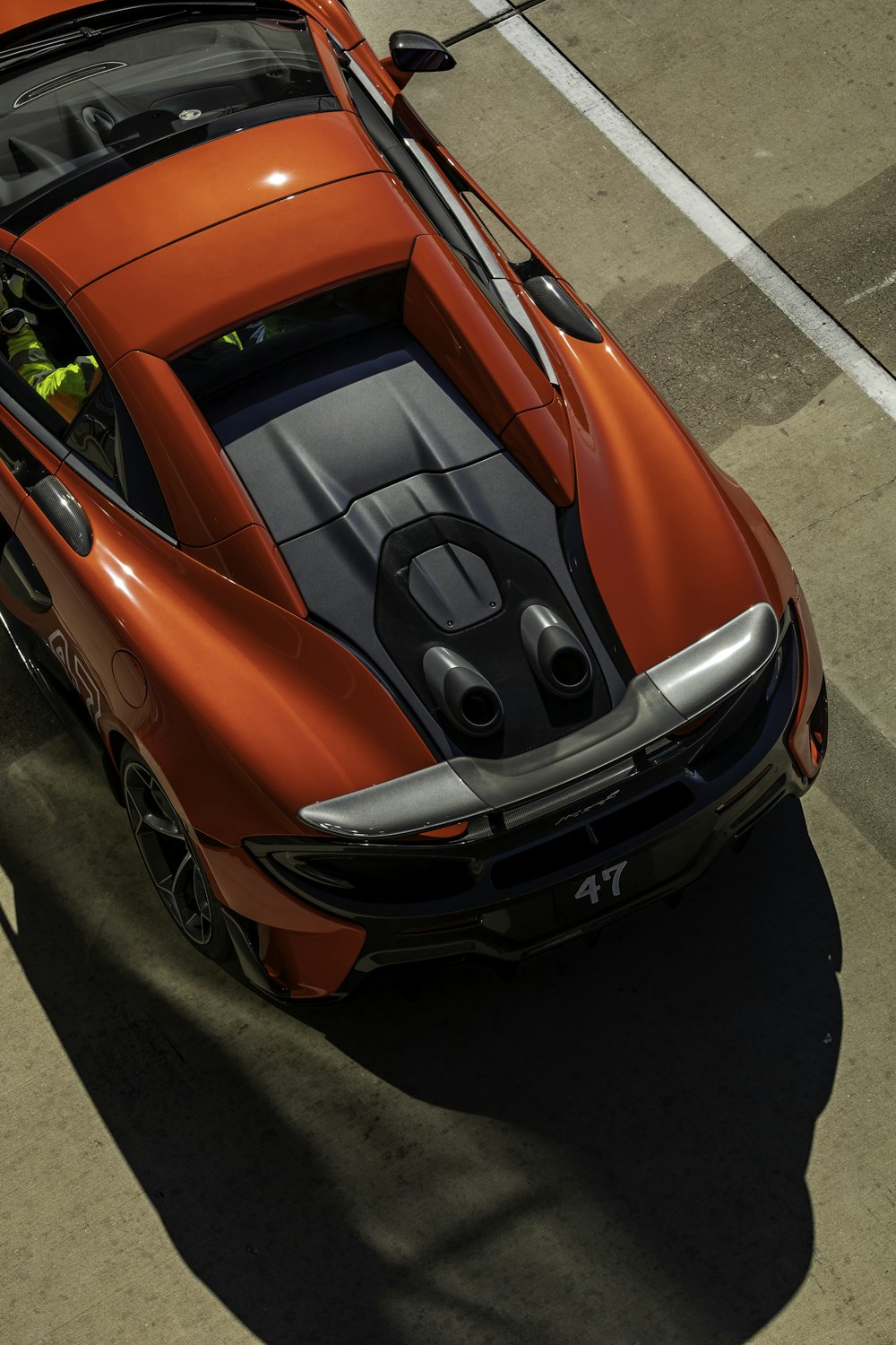 an orange sports car is shown from above