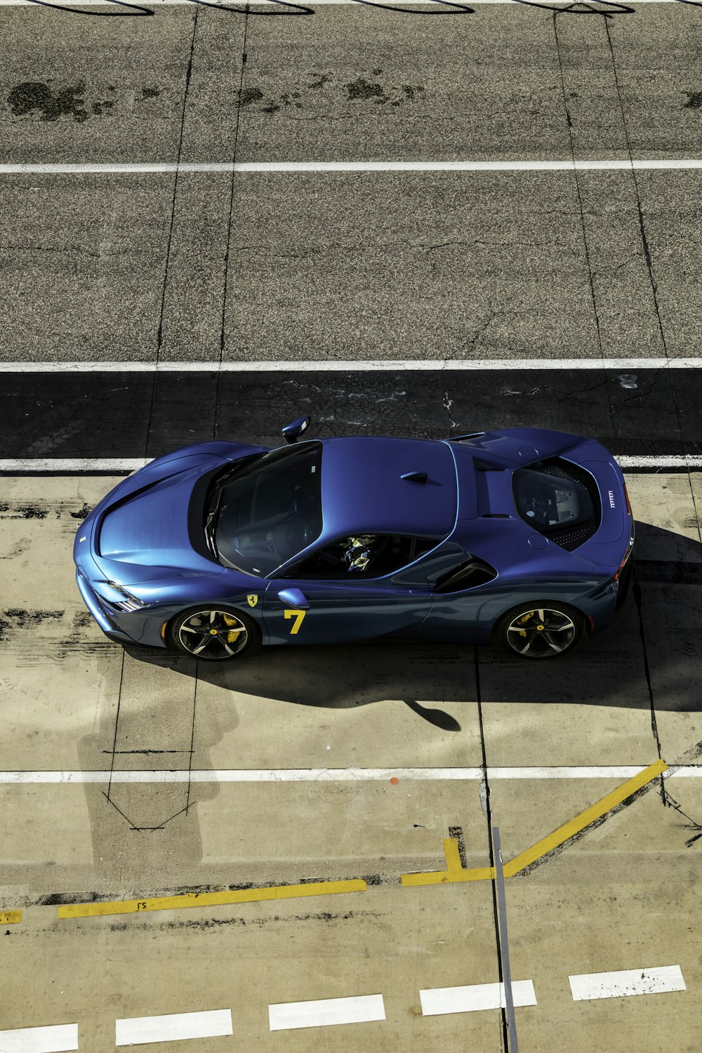 a blue sports car parked on the side of the road