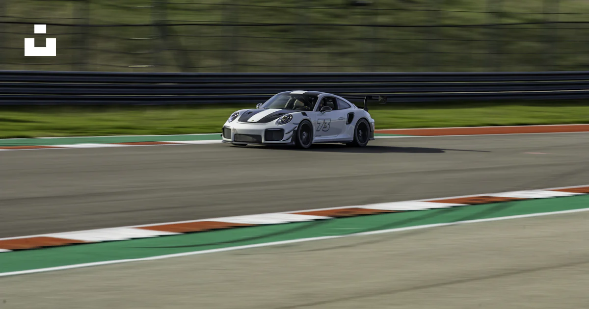 A white car driving down a race track photo – Free Cota Image on Unsplash