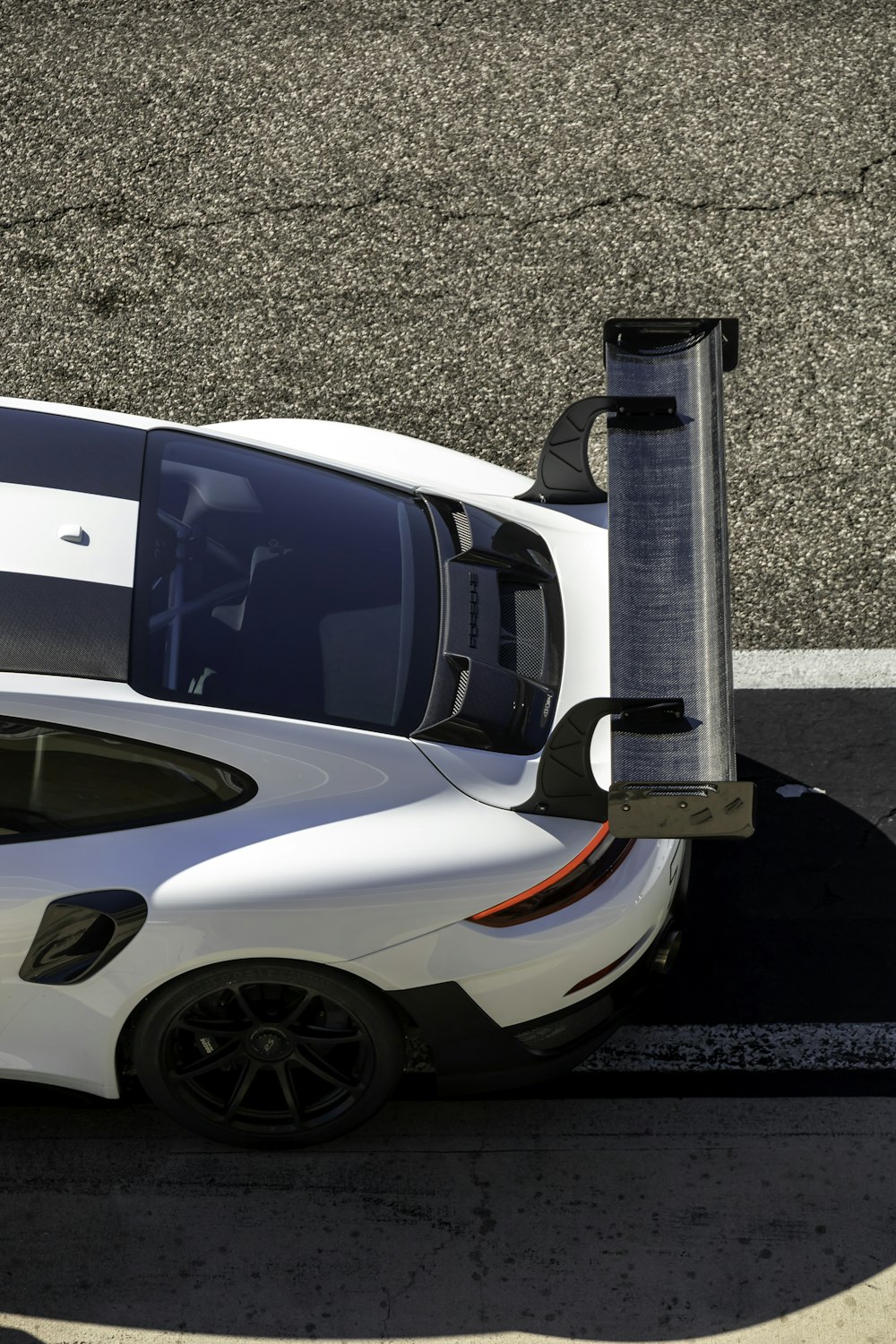 a white sports car parked in a parking lot