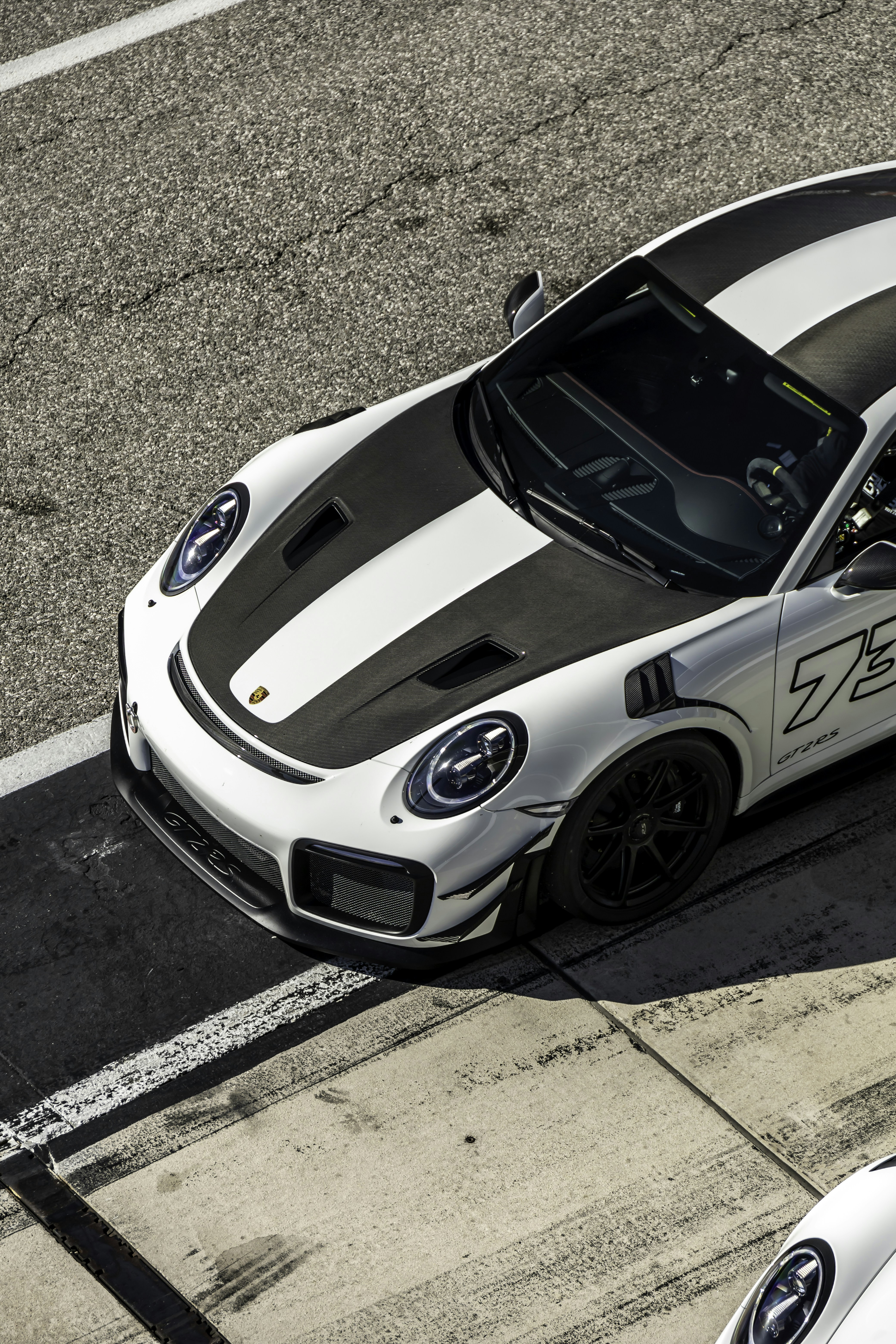 A white sports car driving down a race track photo – Free Wallpaper ...