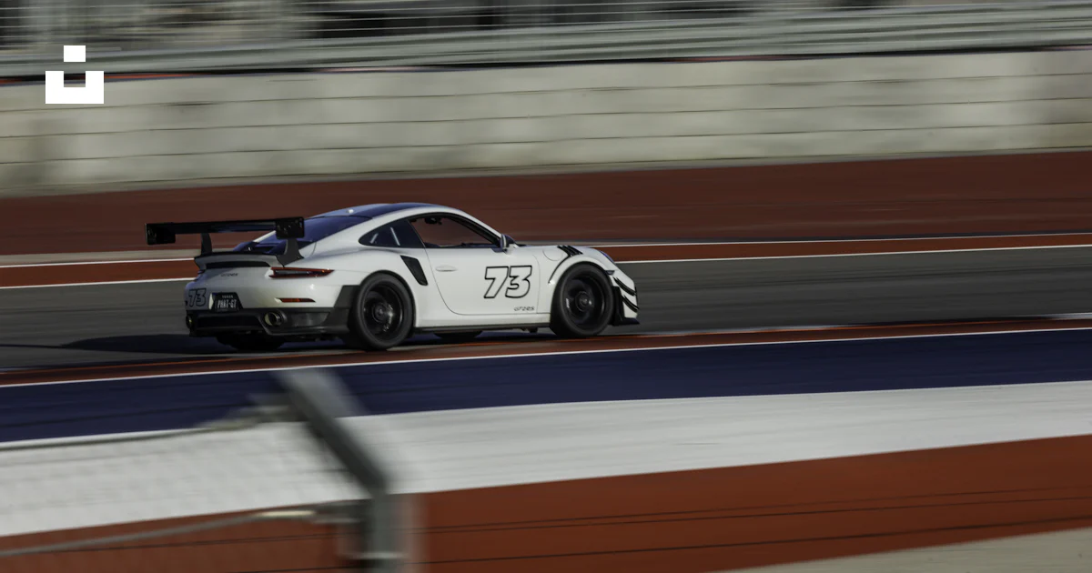 A white car driving down a race track photo – Free Cota Image on Unsplash