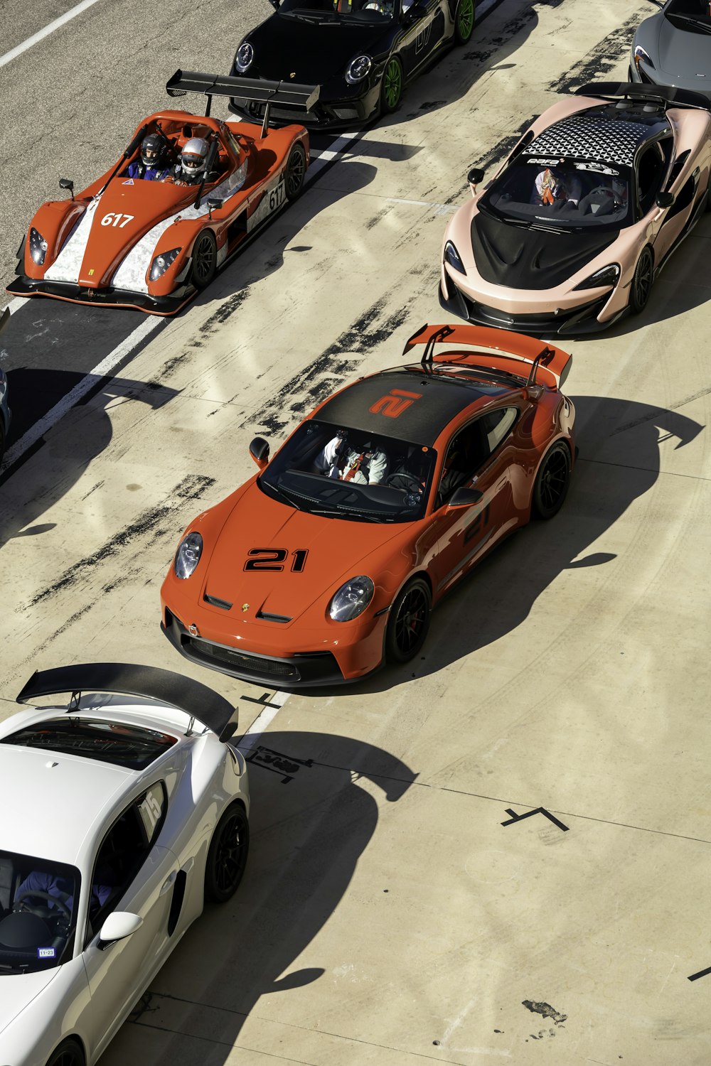 a group of four sports cars parked next to each other