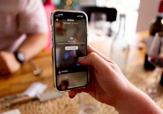 a person holding a cell phone in their hand