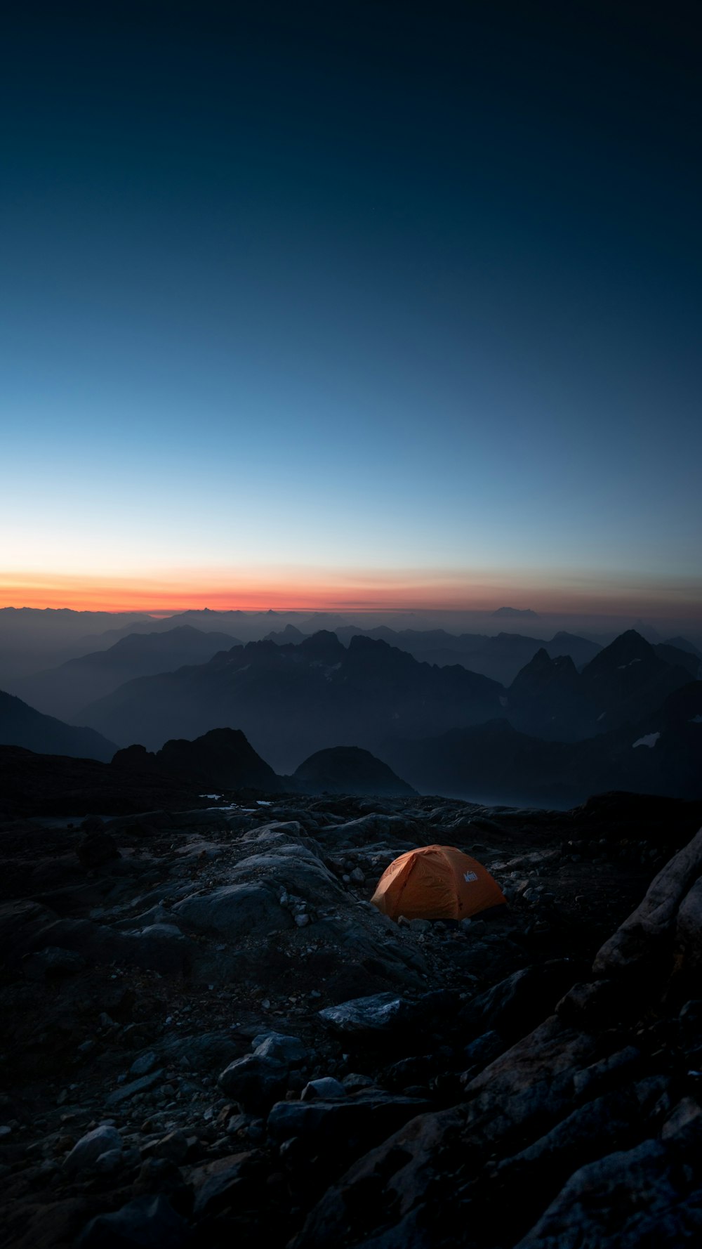a tent pitched up on top of a mountain