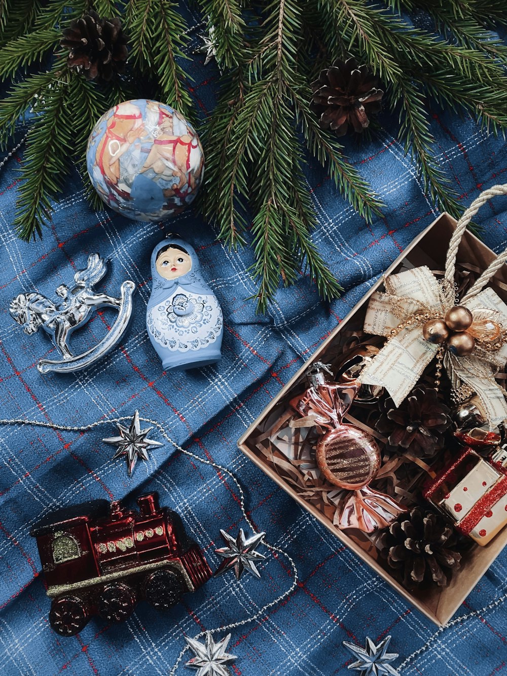 a wooden box filled with christmas decorations next to a christmas tree