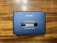 A vintage AIWA stereo cassette player with a blue casing featuring an 'AUTO REVERSE' function. The player rests on a wooden surface, showing signs of wear such as scratches.