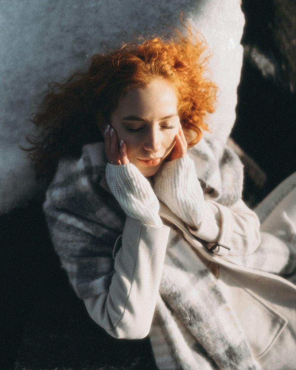 a woman with red hair sitting on a couch