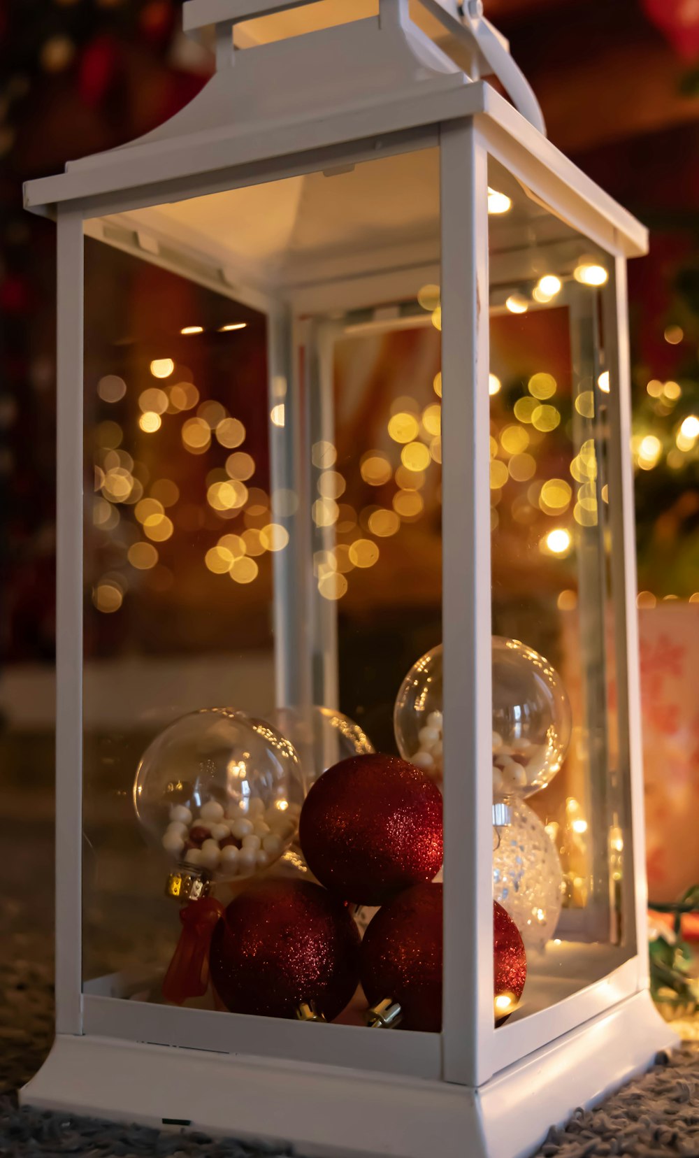 a white lantern with ornaments inside of it