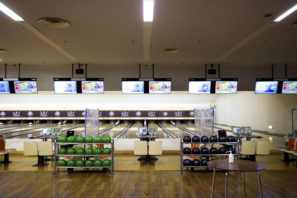 a bowling alley filled with bowling balls and tvs