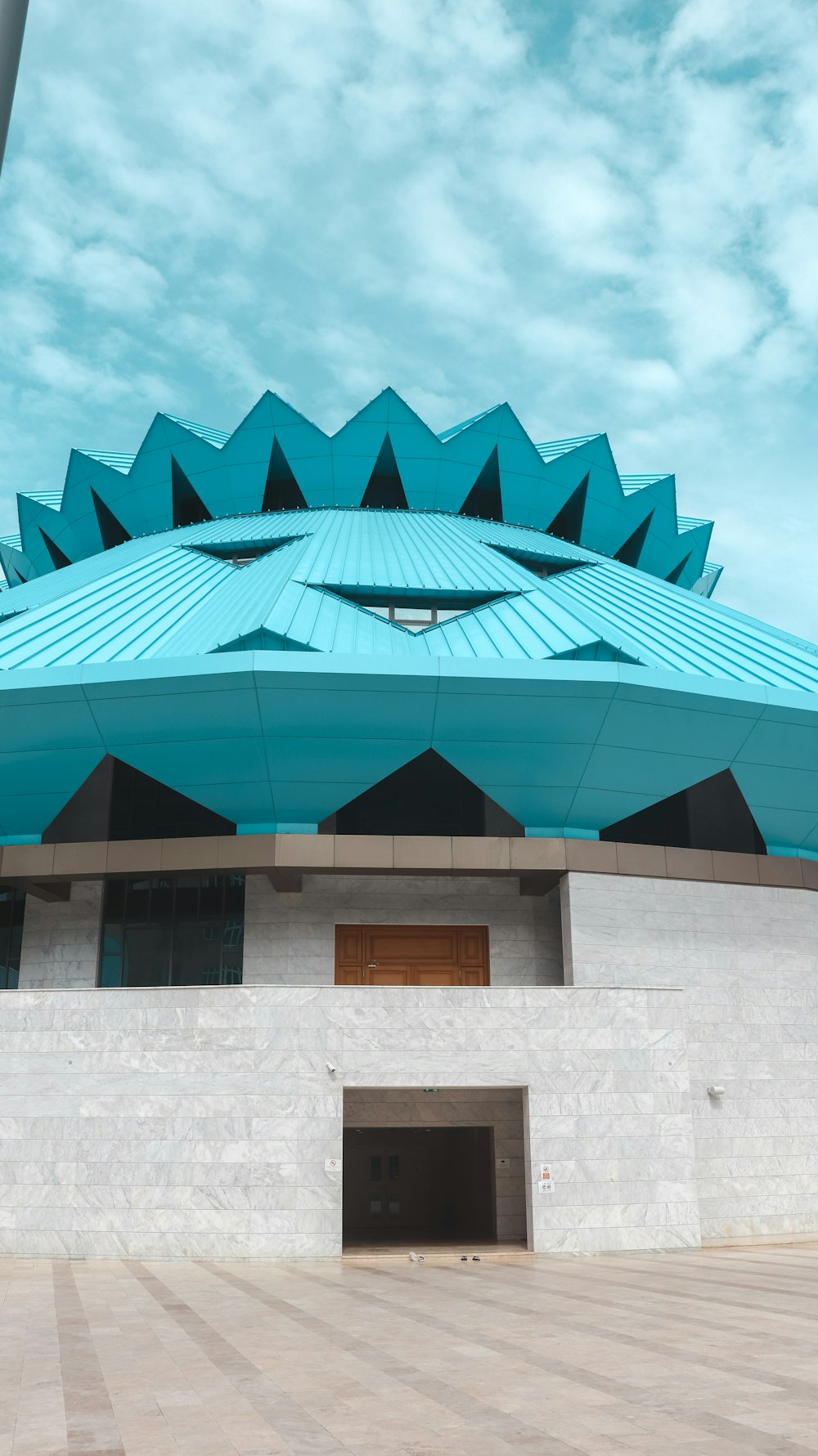 a large building with a blue roof on top of it