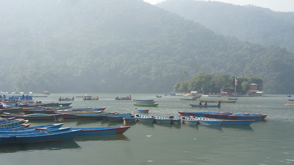 a group of boats floating on top of a lake