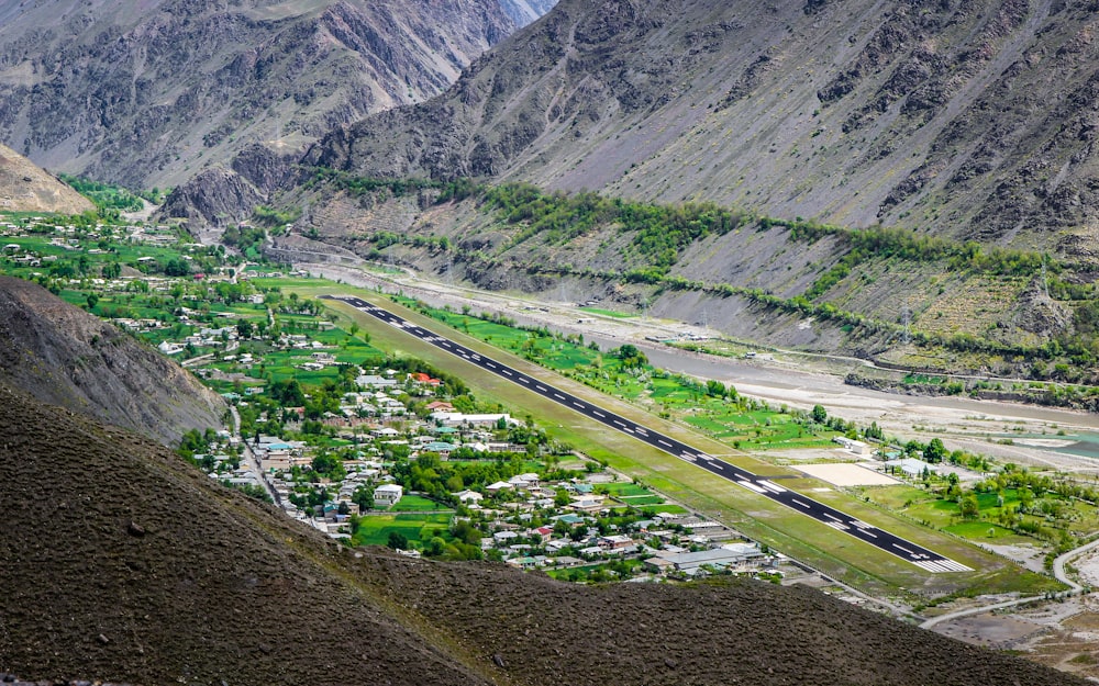 a view of a valley with a train going through it