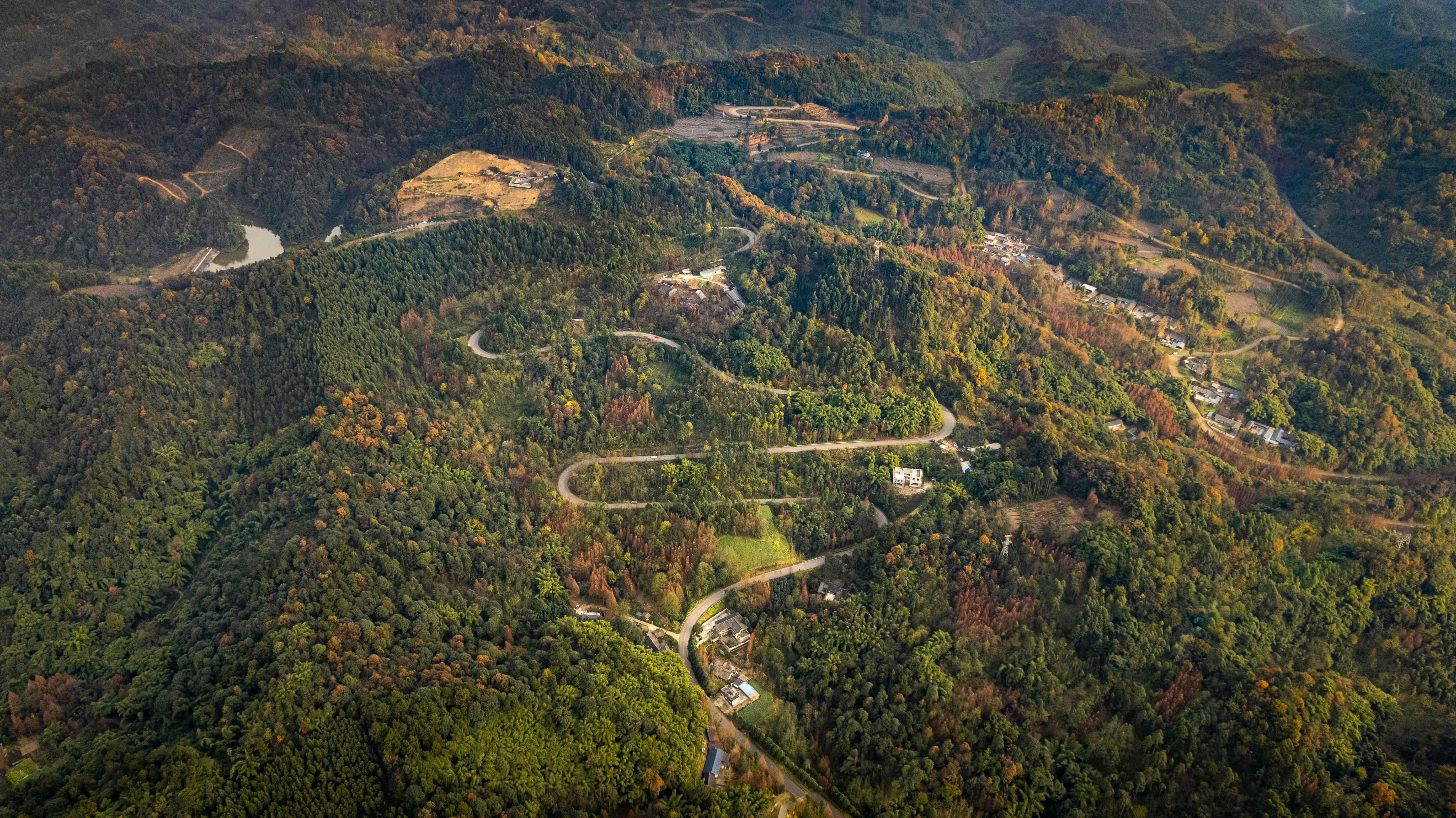 an aerial view of a winding road in the mountains