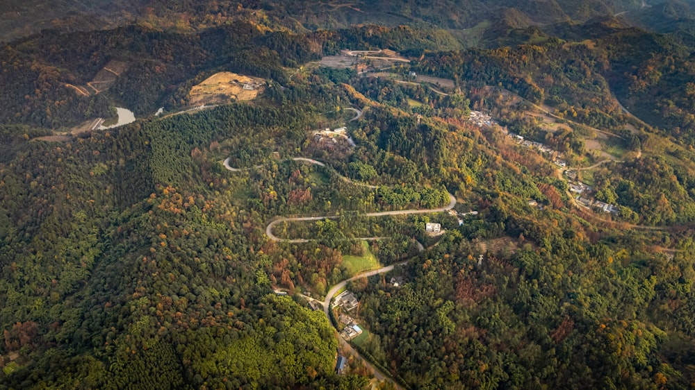 an aerial view of a winding road in the mountains